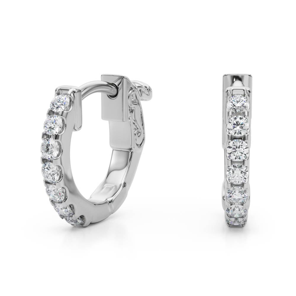 14k white gold diamond huggie hoops from Lovinity’s Unity Collection, featuring a row of sparkling diamonds hugging the earlobe.