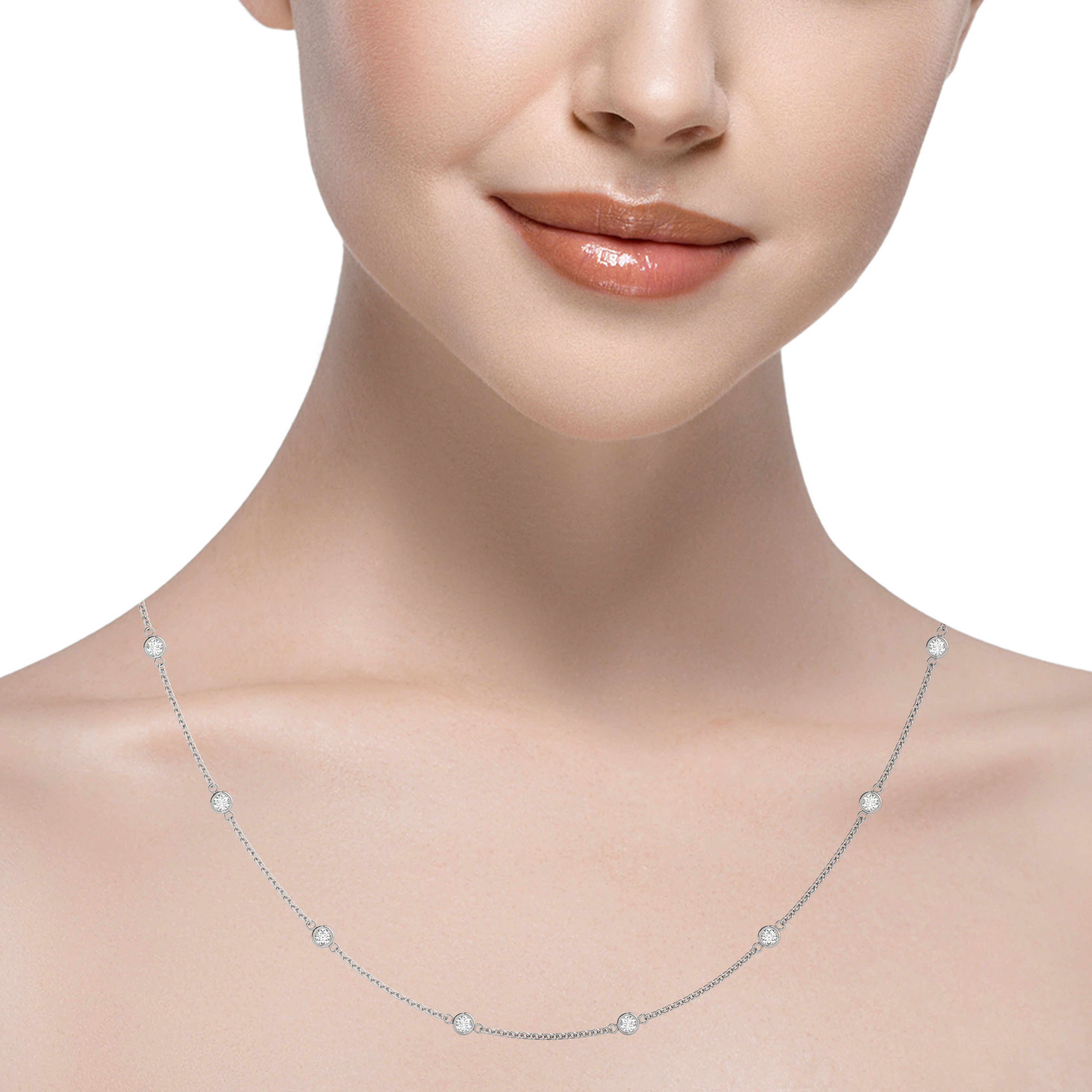 14k gold bezel-set diamond necklace with ten evenly spaced diamonds on a delicate chain.