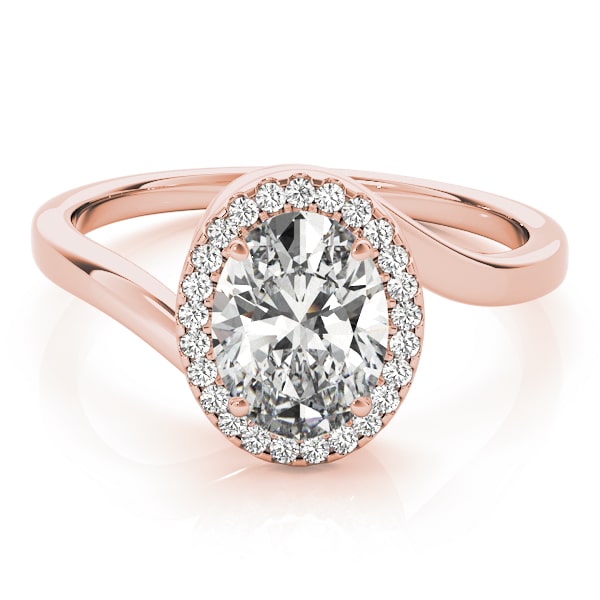 Oval halo lab-grown diamond ring in 14k gold with smaller diamonds encircling the center stone.