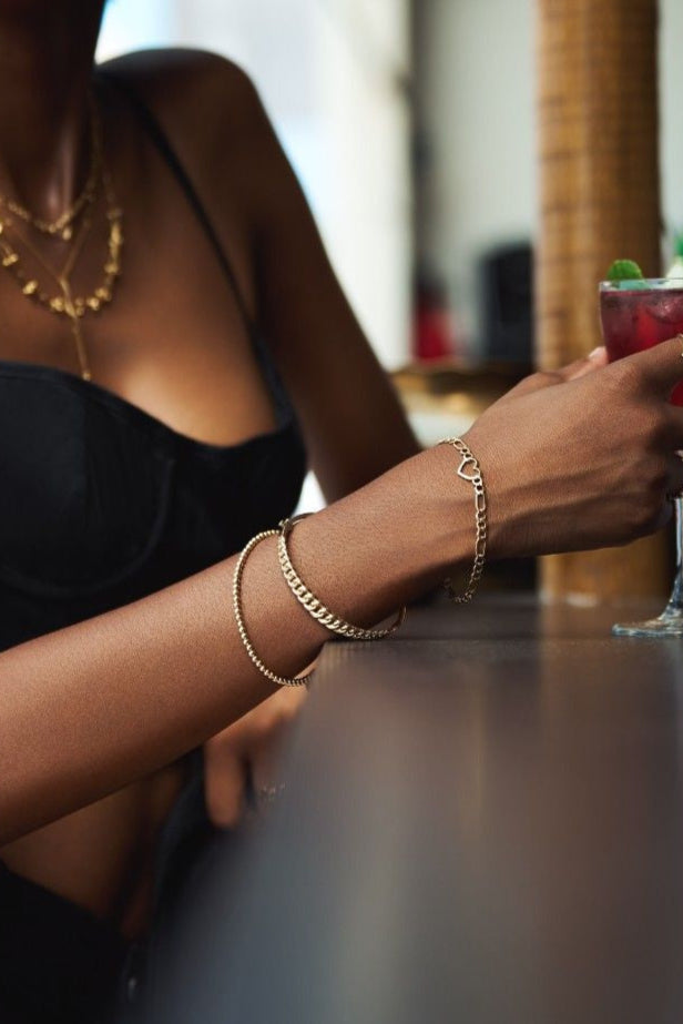 Elegant gold bangle with interwoven chain design, perfect for daily wear or special occasions.
Timeless gold link bangle featuring seamless craftsmanship and bold, interconnected motifs.
Modern link-style gold bangle symbolizing strength and unity, crafted with a sleek silhouette.