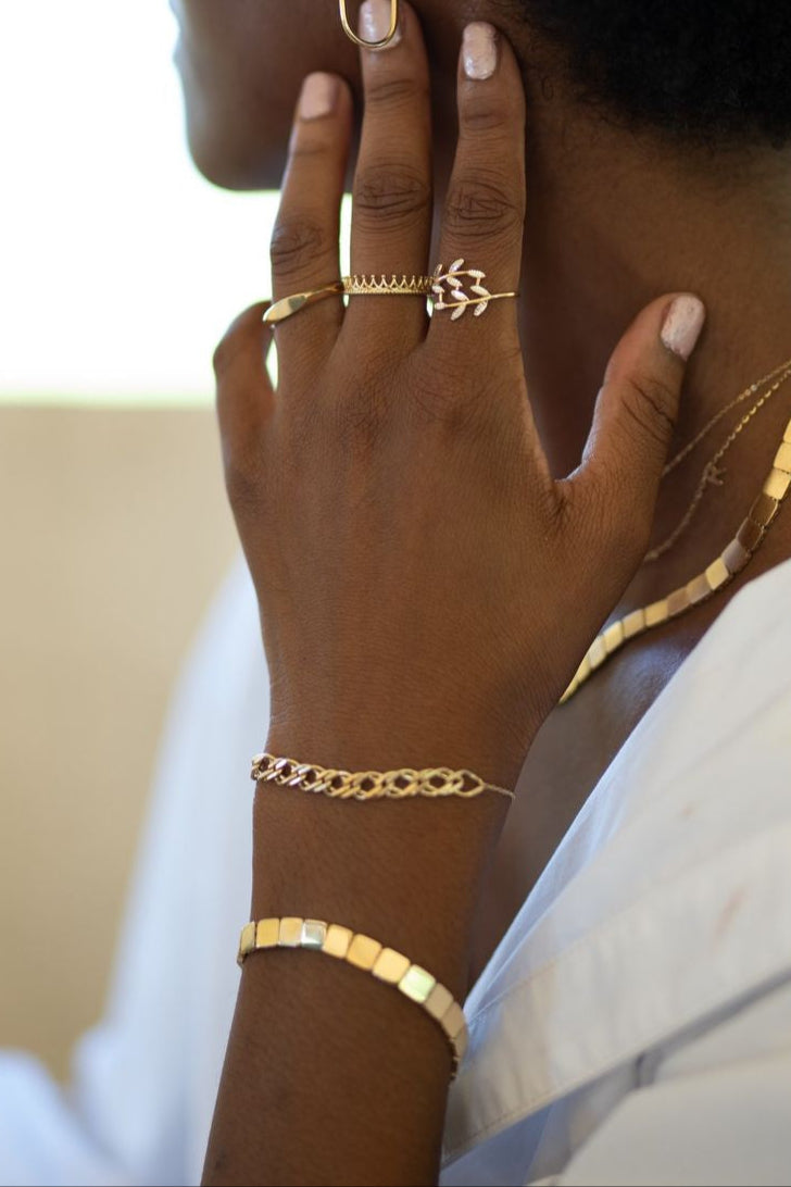 14k gold square link bracelet with polished surface, representing enduring connections and sophistication.