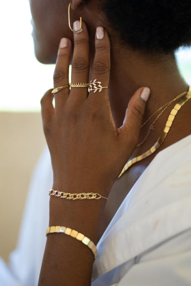 14k gold woven bracelet with intricate link design symbolizing unbreakable connections.