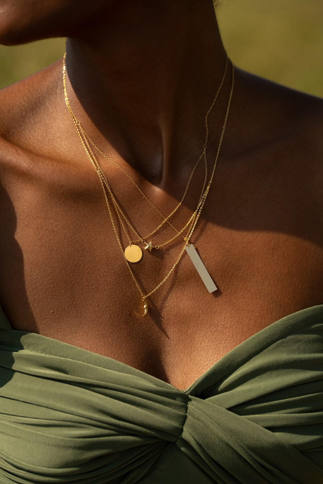 14k gold layered necklace with a smooth disc and vertical bar, symbolizing balance and duality.