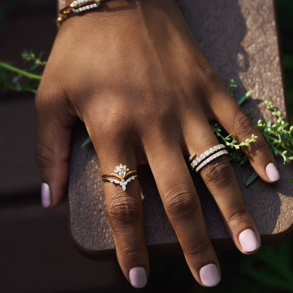 14k gold spiral ring with lab-grown diamonds in a continuous loop design, featuring overlapping bands.