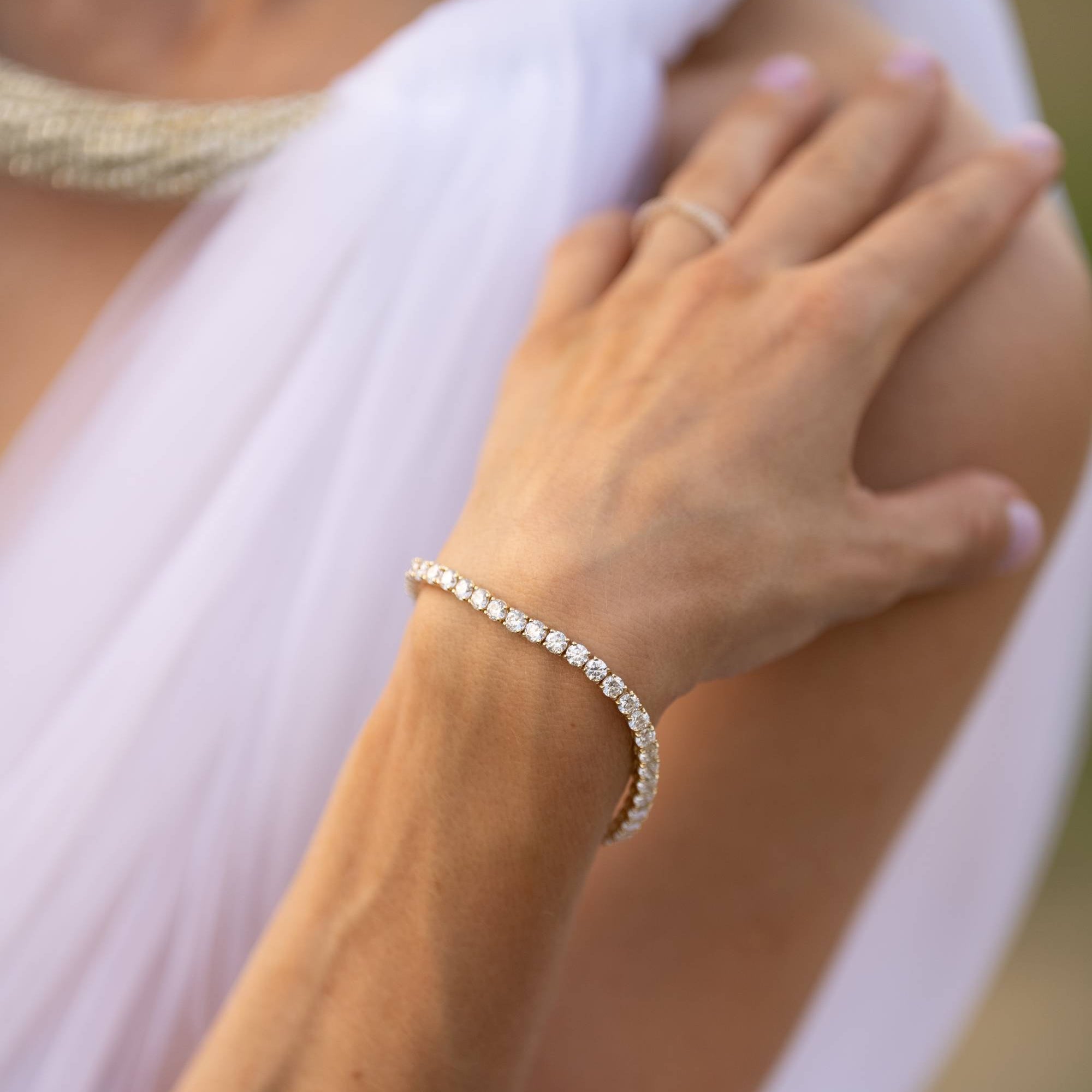 Elegant tennis bracelet featuring lab-grown diamonds in a classic 4-prong setting, crafted in 14k gold.