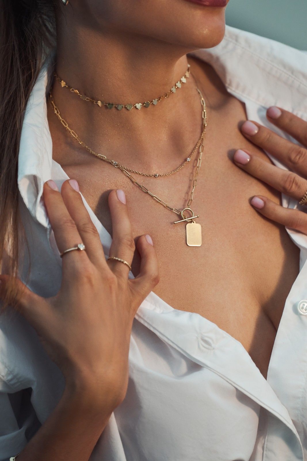 14k gold necklace with linked heart motifs, symbolizing unity, love, and harmonious relationships.