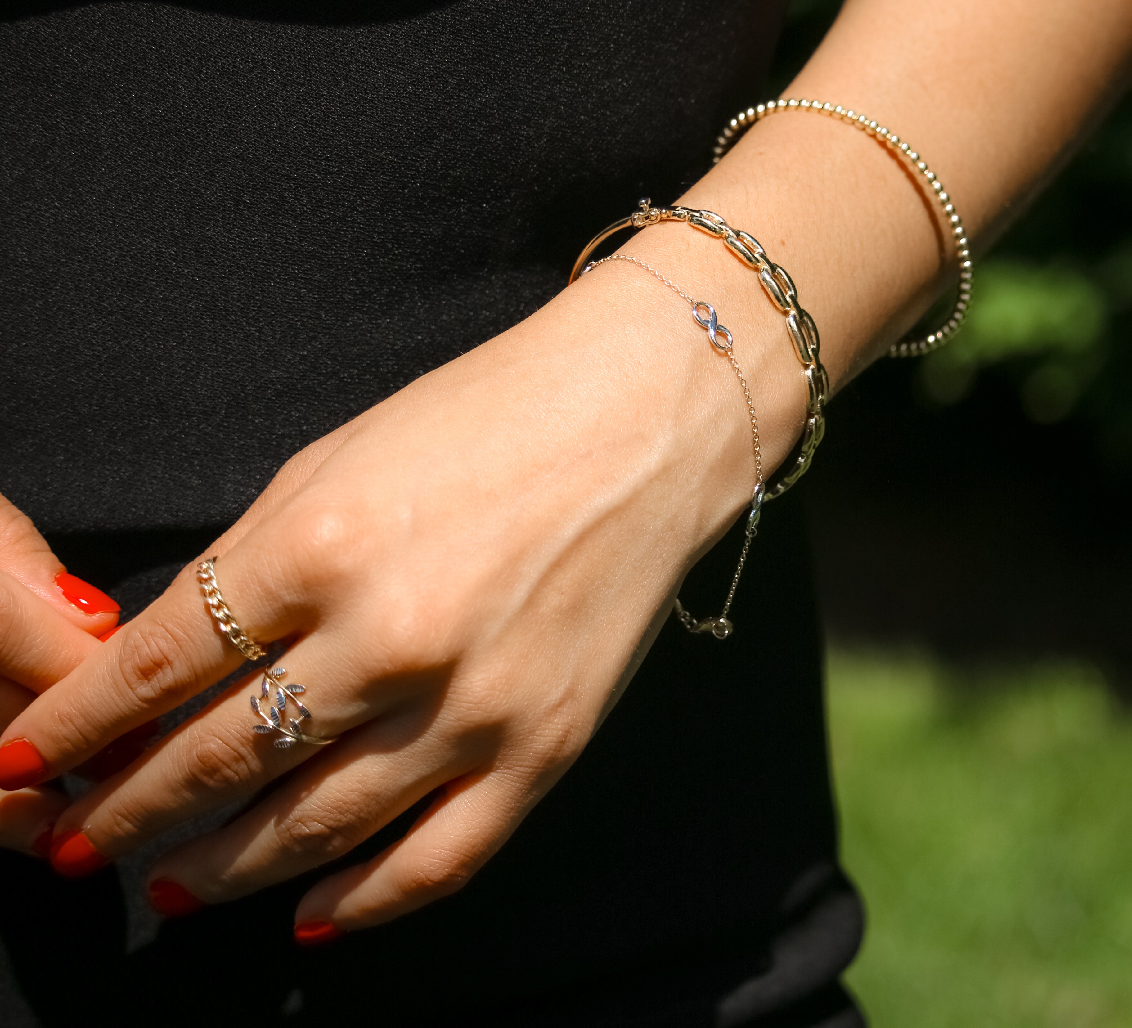 Gold bracelet featuring interlinked infinity symbols, representing eternal love and unity.