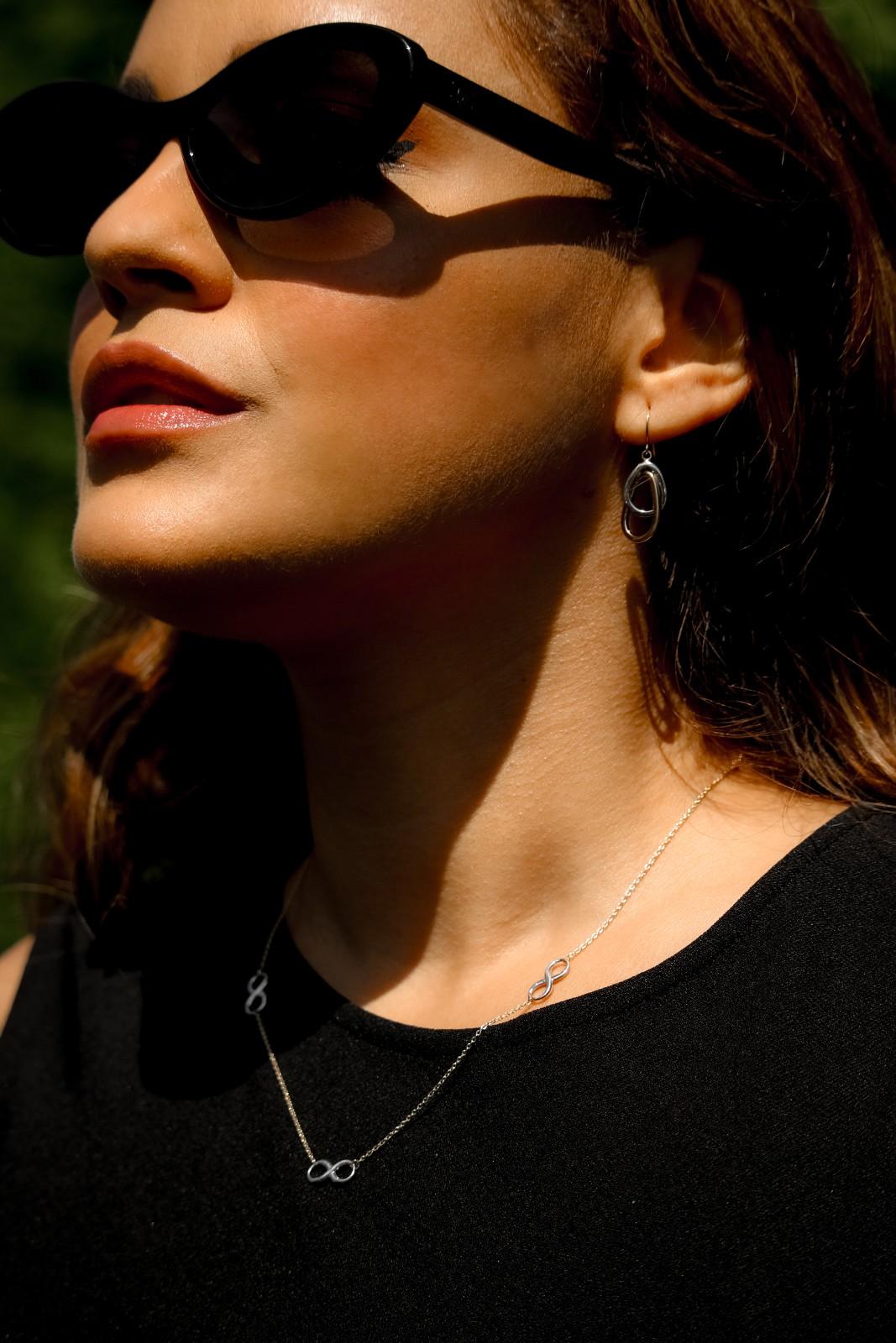 Interlocking loop earrings crafted in 14k gold with a fluid, modern design.