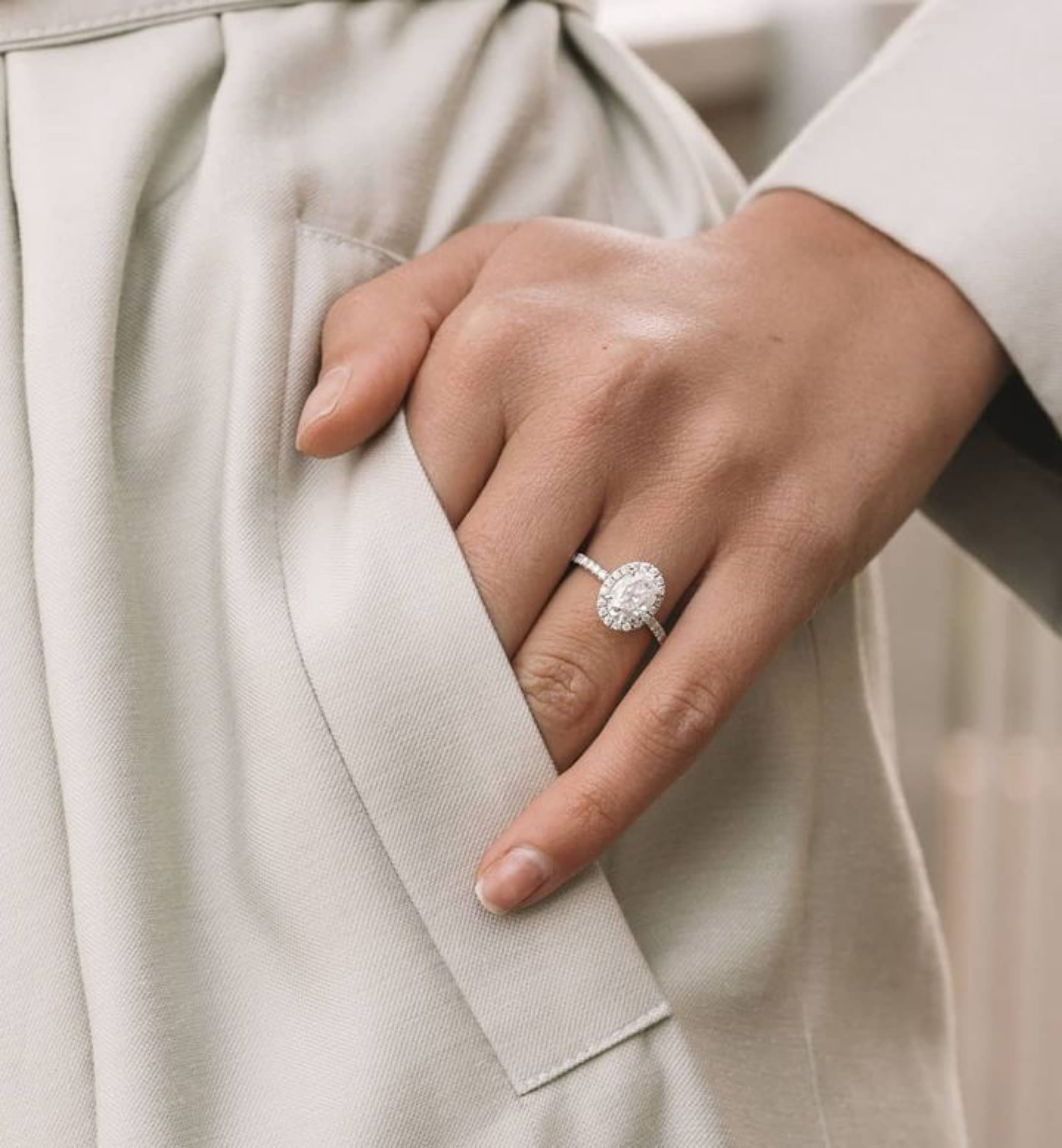 14k gold oval diamond halo engagement ring with pavé-set diamonds symbolizing eternal love.