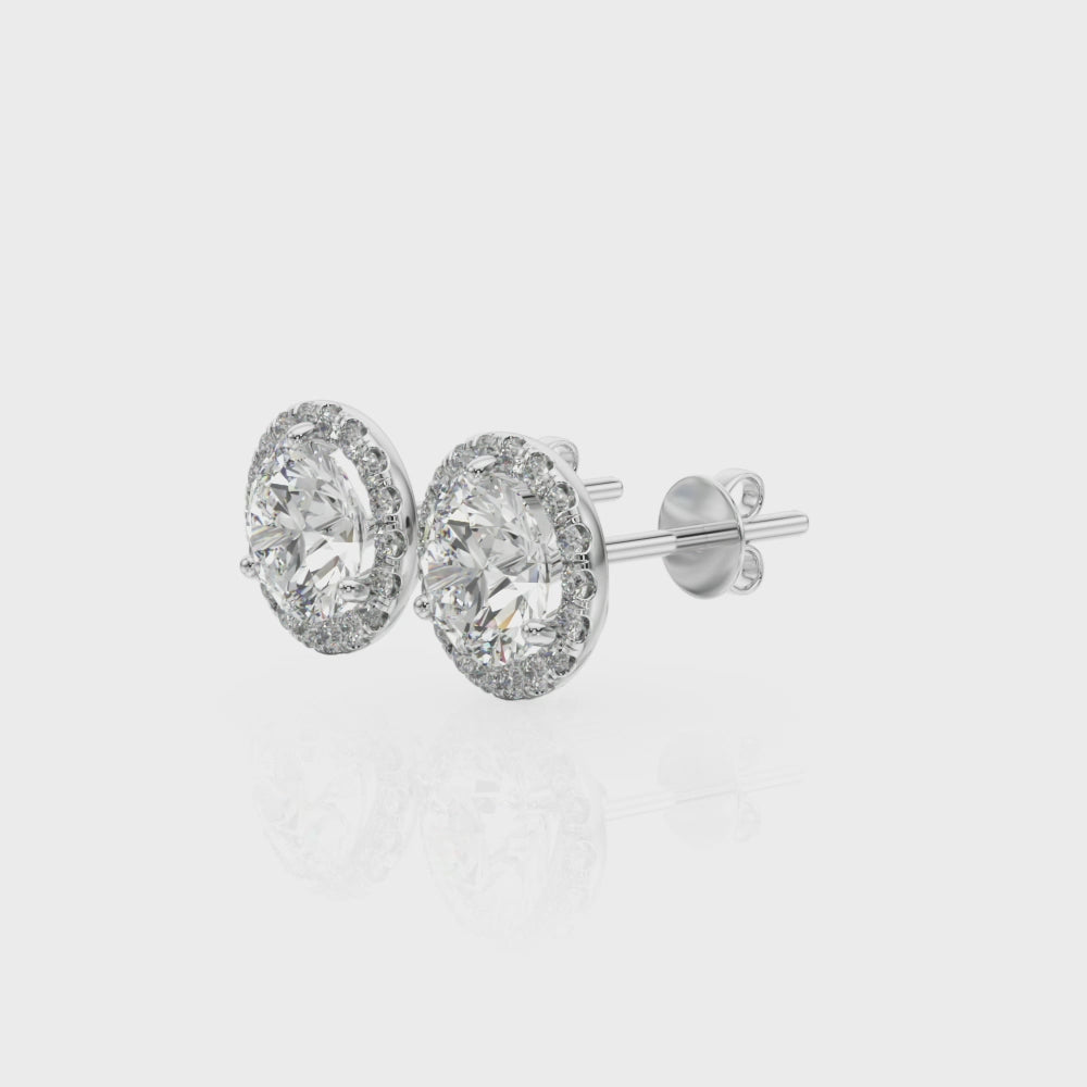 14k white gold halo diamond stud earrings from Lovinity’s Unity Collection, featuring a central Lovinity diamond encircled by smaller diamonds.