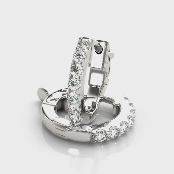 14k white gold diamond huggie hoops from Lovinity’s Unity Collection, featuring a row of sparkling diamonds hugging the earlobe.