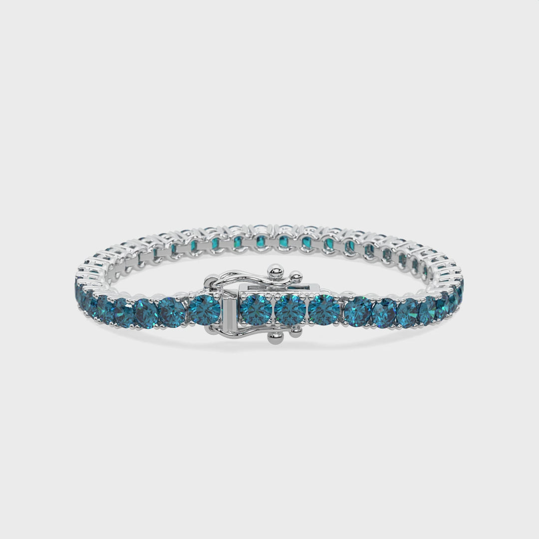 14k gold bracelet with vivid blue lab-grown diamonds in a 4-prong setting.
Elegant tennis bracelet featuring round blue diamonds in a flowing design.
Close-up of The Eternal Flow Bracelet with blue diamonds and white gold craftsmanship.